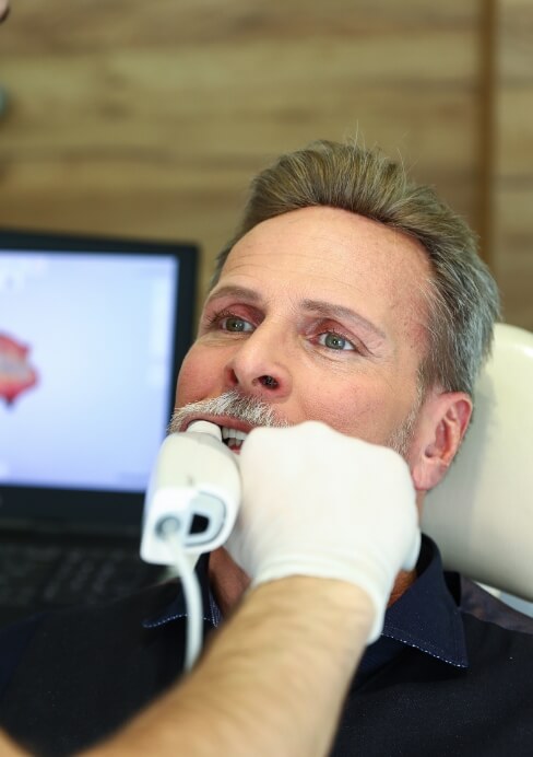 Dental patient receiving VELScope oral cancer screening