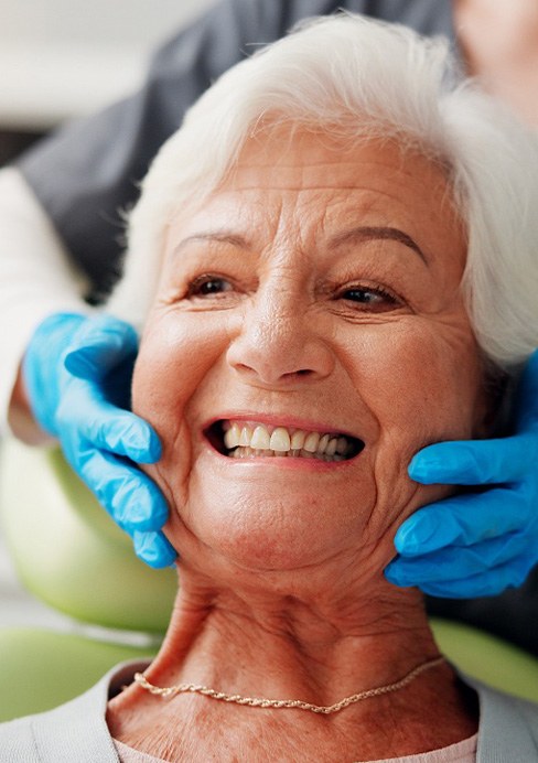 A woman smiling at the dentist
