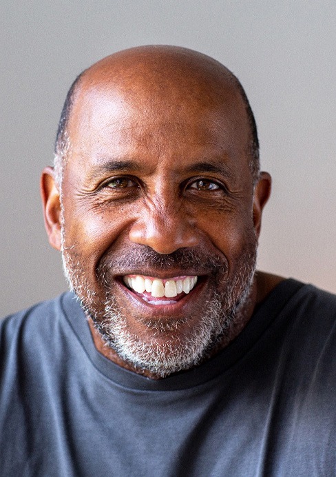 Closeup of senior man in gray shirt smiling