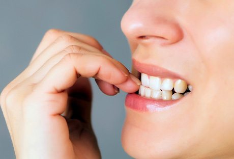 Closeup of patient biting their nails