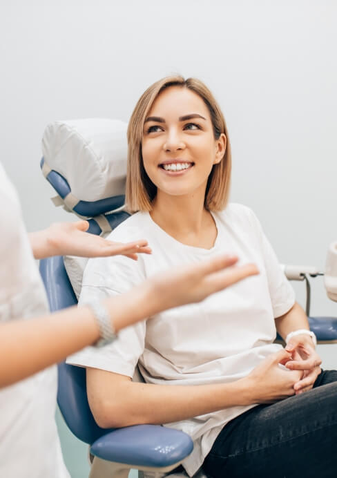 Woman in dental chair smiling