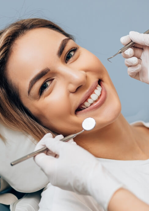 Smiling woman receiving a dental checkup