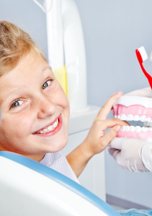 Young dental patient smiling while visiting children's dentist