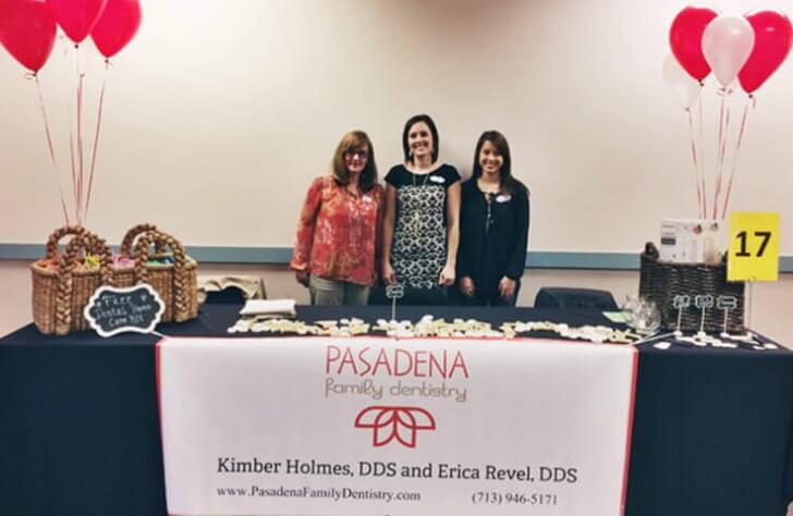 Three dental team members volunteering at a community event