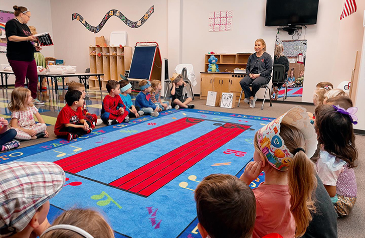 Dental team member presenting to classroom full of kids