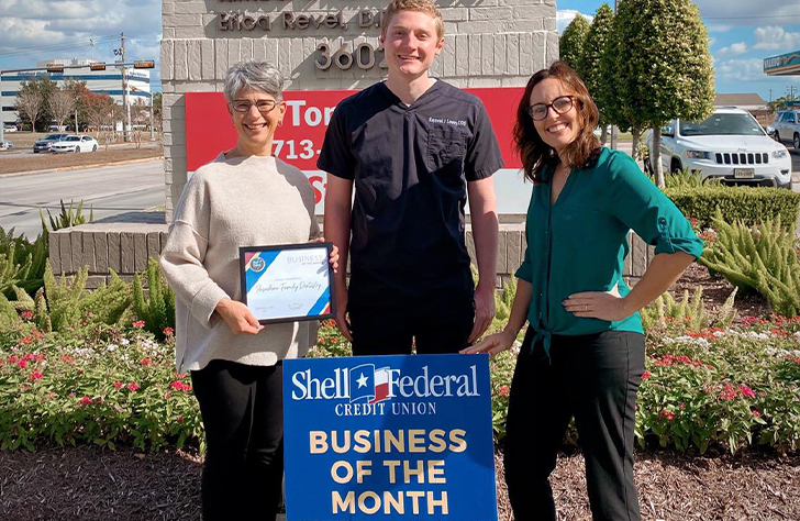 Our Pasadena Texas dentists in front of Business of the Month award sign