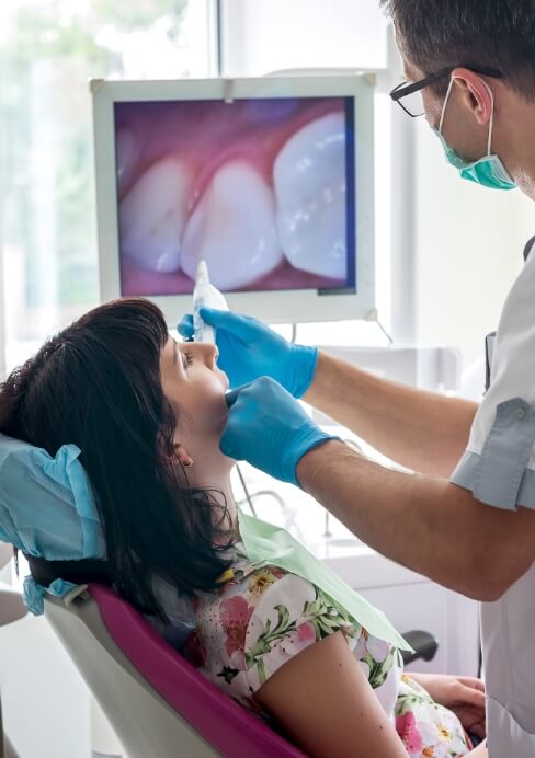 Dentist using intraoral camera to capture smile images