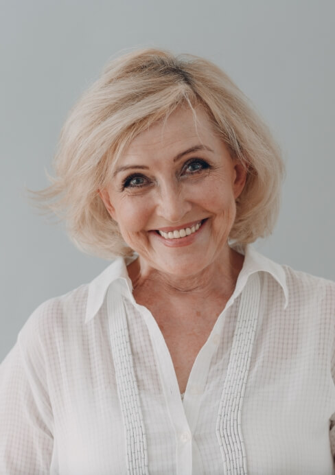 Smiling woman enjoying the benefits of dentures