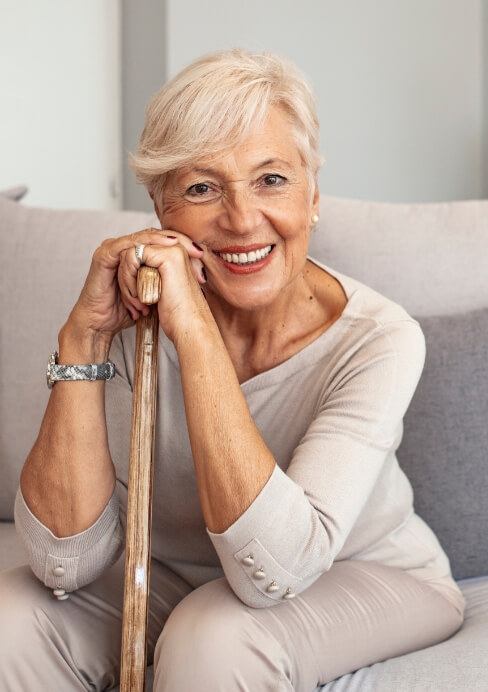 Woman with dentures sharing healthy smile