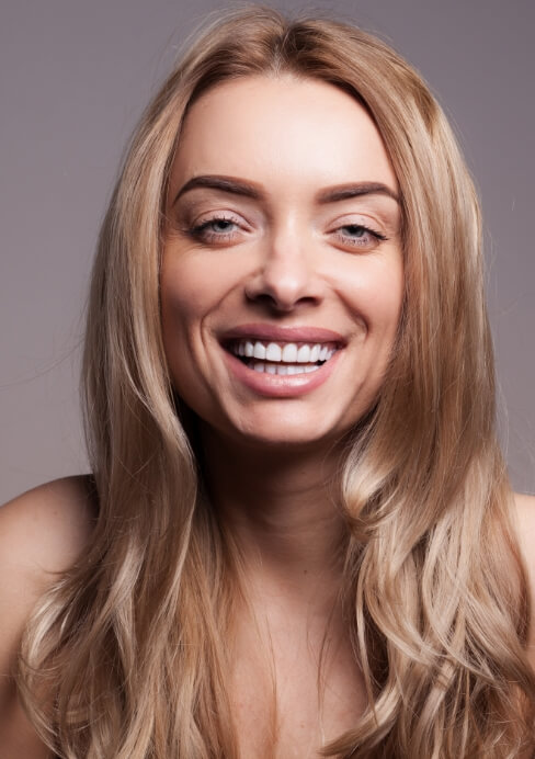 Woman with flawless smile after dental bonding