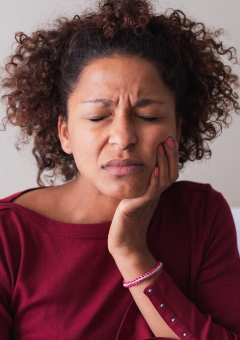 Woman in pain before gum recontouring