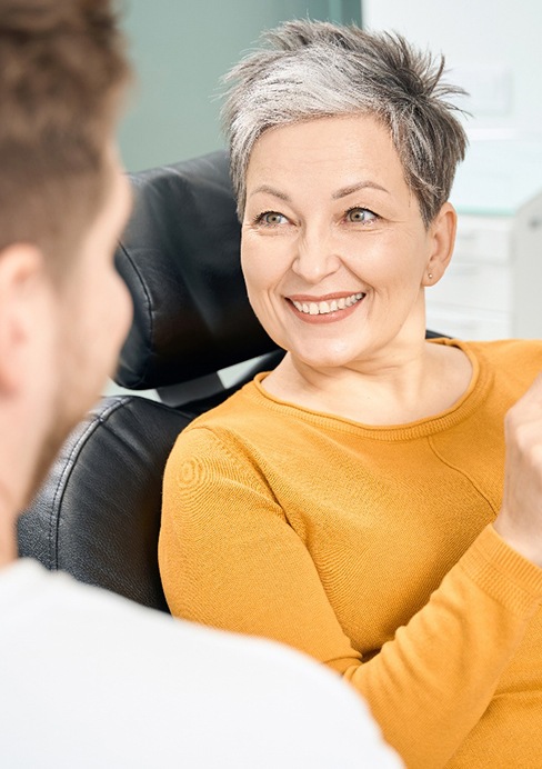  A woman at an implant denture consultation with her dentist