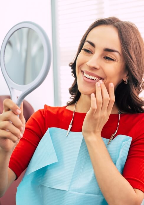 Smiling woman enjoying the benefits of dental implants