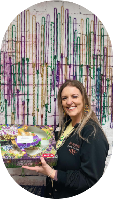 Dental team member holding mardi gras cake