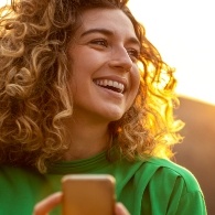 Woman smiling after replacing missing teeth