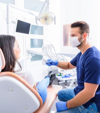 Dentistry team member talking to dental patient