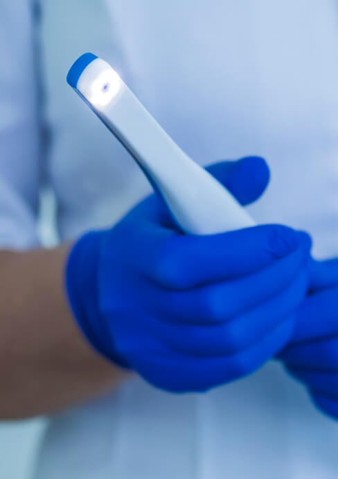 Closeup of dentist holding an intraoral camera