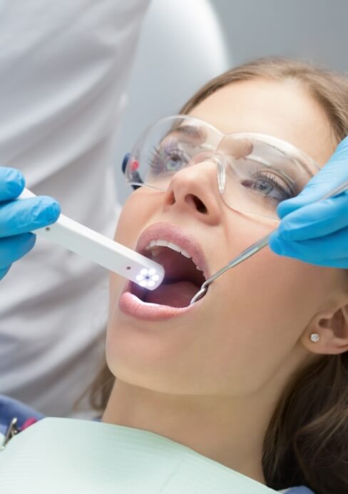 Dentist using intraoral camera to capture images of dental patient's smile
