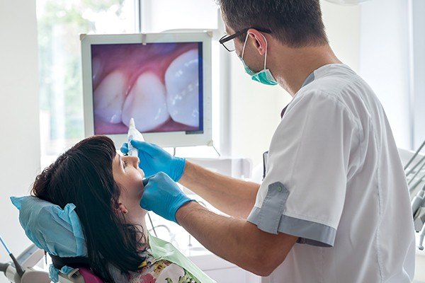 Dentist using intraoral camera to capture smile images