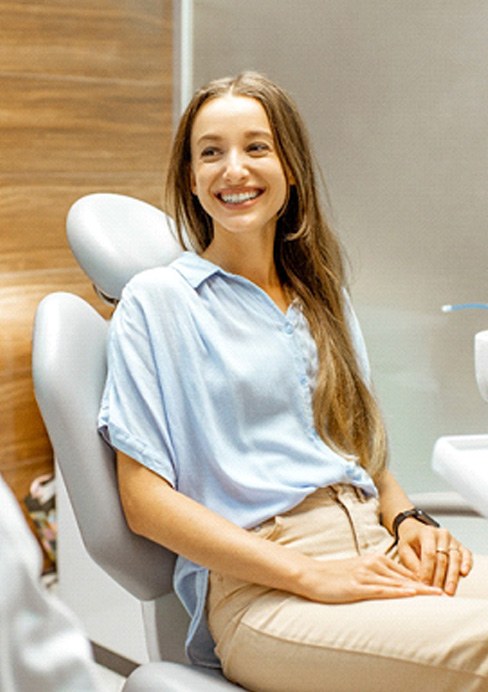 Female patient smiling at dentist at dental appointment