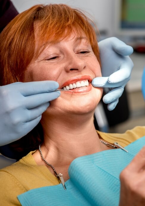 Woman smiling after tooth extractions