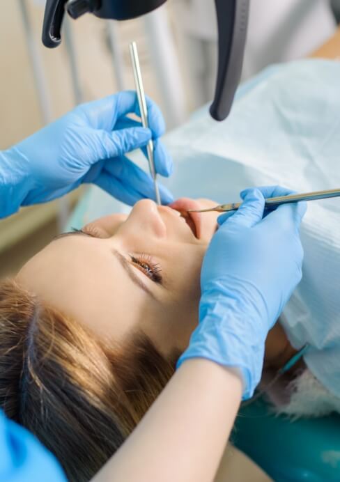 Dentist performing root canal treatment