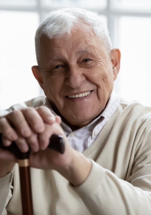 Older man smiling after senior dentistry