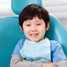 Child smiling during visit to see his children's dentist
