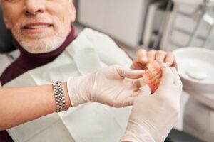 Man getting his dentures relined